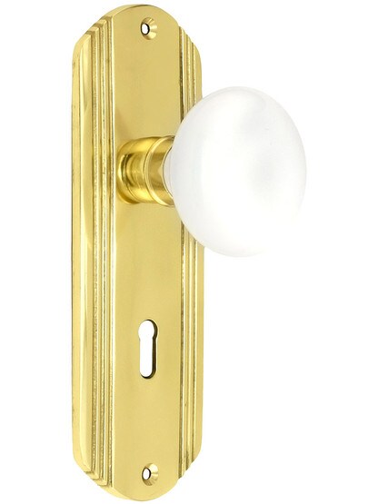 Streamline Moderne Mortise Lock Set With White Porcelain Door Knobs in Polished Brass.